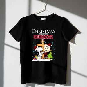 Snoopy and Charlie Brown Cross Christmas Begins With Sooners 1 T Shirt.jpg